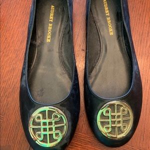 Audrey Brooke black flat with gold emblem